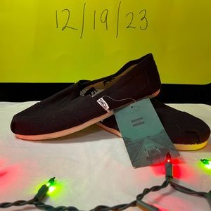 TOMS black slip ons with tags